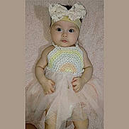 Ailani is registered to the contest to win money with this photo: adorable, baby, blanket, bow, child, crochet, cute, dress, face, fashion, hands, headband, indoors, infant, lying_down, pastel_colors, portrait, soft_texture, tulle, young_child