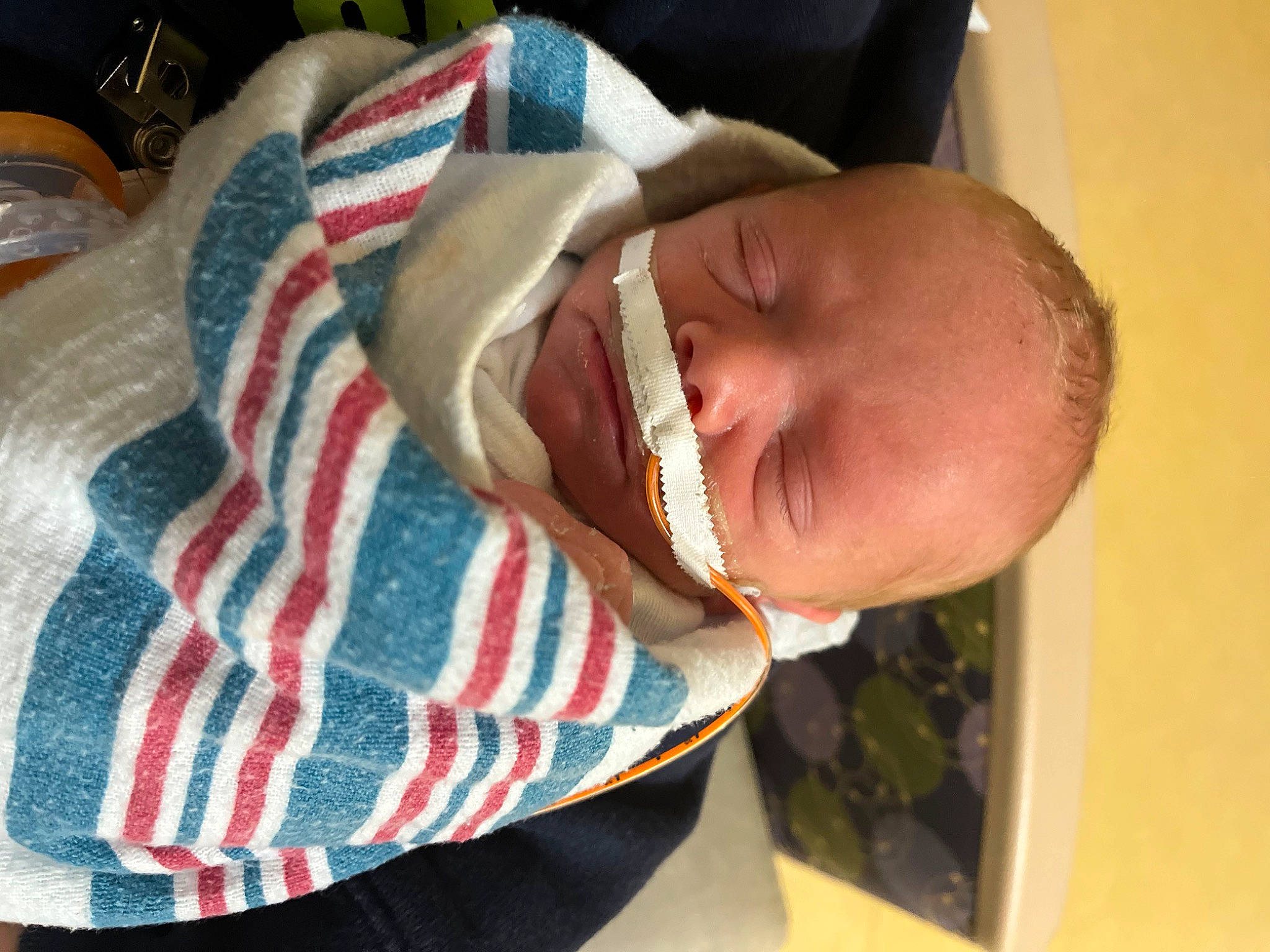 Garrett is registered to the contest to win money with this photo: baby, baby_products, baby_toddler_clothing, carmine, cheek, child, comfort, happy, linens, pattern, person, plaid, smile, tartan, thumb, toddler, wrinkle