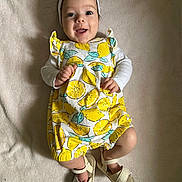 Bellamy joined the competition — help win amazing prizes! baby, infant, smiling, headband, flower, lemon_pattern, romper, white_sandals, lying_down, blanket, happy, cute, child, clothing, footwear, portrait, indoors, person, baby_fashion, soft_texture