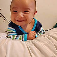 Way joined the competition — help win amazing prizes! baby, smile, infant, striped_clothing, blanket, indoor, happy, child, person, young, cute, portrait, cozy, bedroom, soft, hand, face, head, warm_light, cheerful