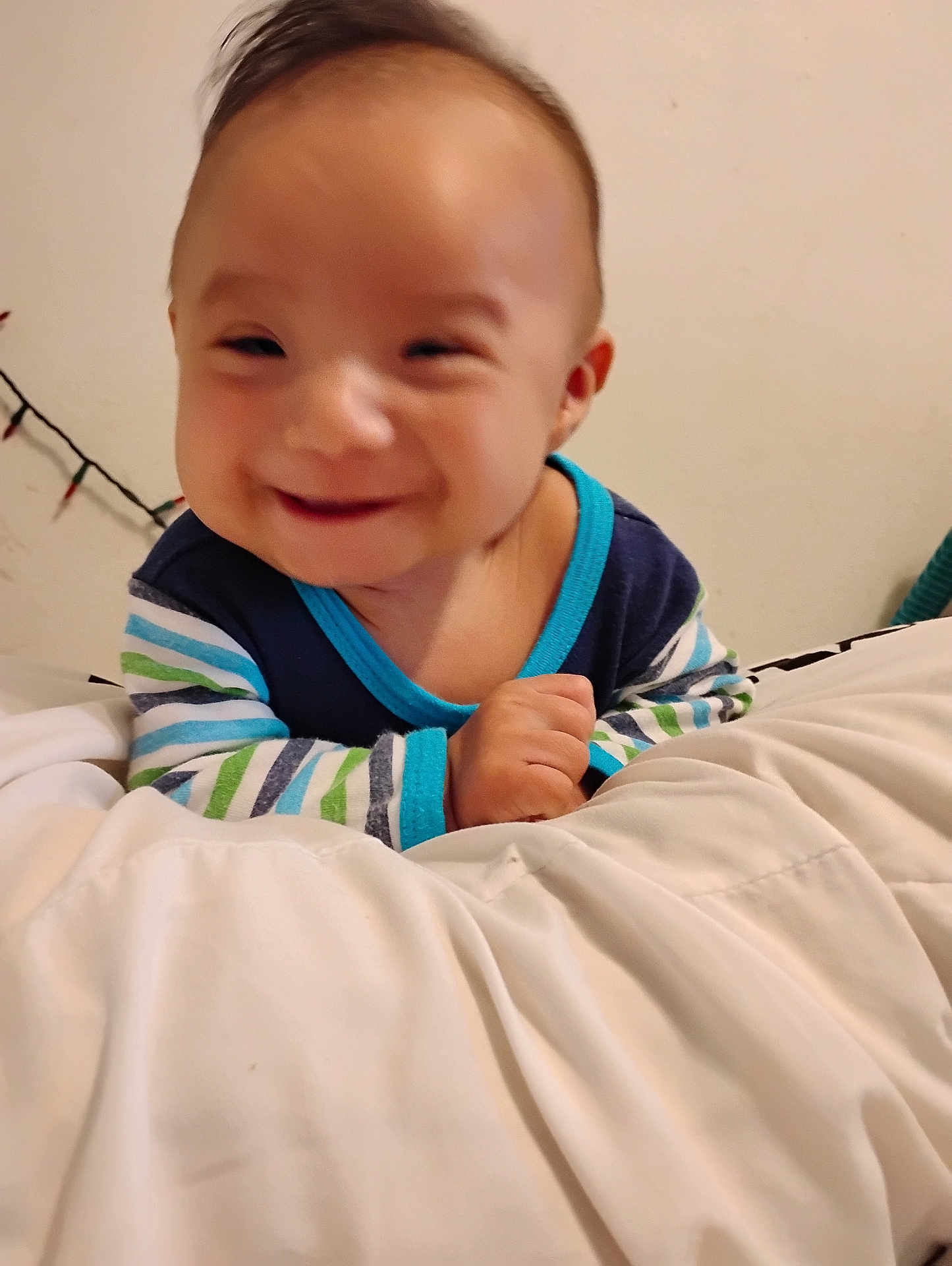 Way joined the competition — help win amazing prizes! baby, smile, infant, striped_clothing, blanket, indoor, happy, child, person, young, cute, portrait, cozy, bedroom, soft, hand, face, head, warm_light, cheerful