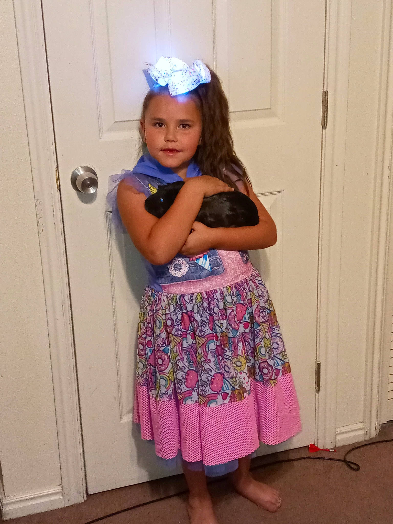 Alisa is registered to the contest to win money with this photo: baby_toddler_clothing, day_dress, door, electric_blue, event, human_leg, leg, magenta, one_piece_garment, pattern, person, pink, purple, shoulder, sleeve, standing, thigh, toddler, trunk, violet