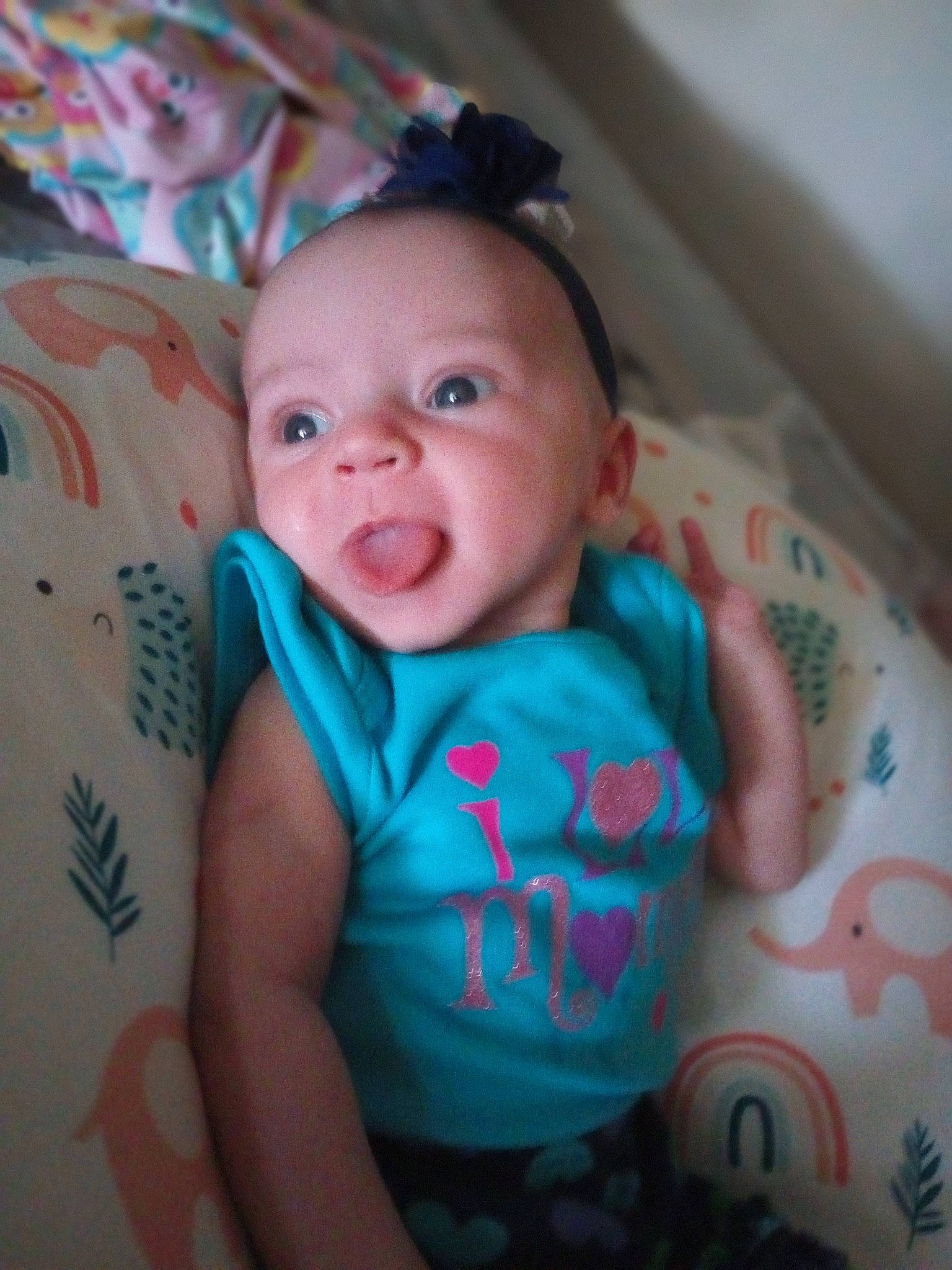 Angelica is registered to the contest to win money with this photo: baby, baby_toddler_clothing, cheek, child, comfort, finger, fun, happy, iris, linens, mouth, neck, nose, person, product, room, skin, sleeve, smile, textile