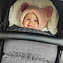 Romane a rejoint le concours — aidez-le/la à gagner de superbes lots ! baby, child, smiling, hood, pink, ears, stroller, blanket, cozy, cute, face, person, winter_clothing, fur, comfort, infant, warm, seat, safety_bar, portrait