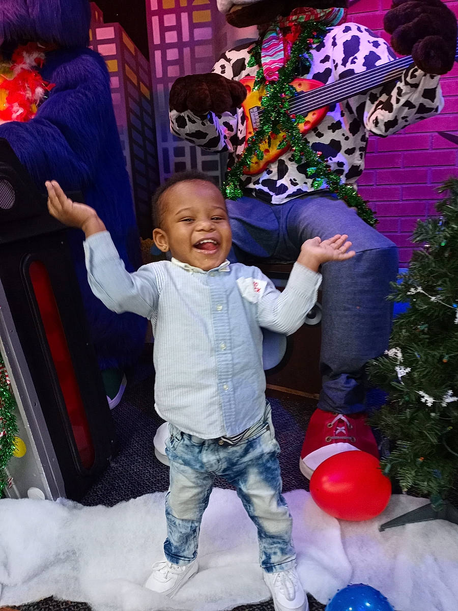 Shavon is registered to the contest to win money with this photo: baby, baby_toddler_clothing, christmas, christmas_decoration, christmas_eve, christmas_ornament, christmas_tree, conifer, fir, holiday, human, interior_design, laugh, ornament, party_supply, person, pine_family, play, purple, toy