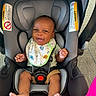 baby, car_seat, smile, bib, infant, seatbelt, child, happy, cute, foot, clothing, indoor, person, safety, head, skin, baby_boy, seat, photography, car_seat_strap
