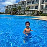 Zayn joined the competition — help win amazing prizes! child, swimming_pool, smiling, outdoor, resort, vacation, water, summer, sunny, apartment, architecture, palm_trees, blue_sky, clouds, portrait, happy, swimming, reflection, poolside, travel