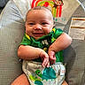 Braylen joined the competition — help win amazing prizes! baby, infant, smile, green_shirt, baby_seat, rainbow, monkey_illustration, chubby_cheeks, cute, happy, hands, clothing, pattern, colorful, child, portrait, indoor, seat, comfort, bright