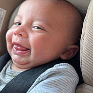 Braylen is registered to the contest to win money with this photo: baby, infant, car_seat, smile, tongue_out, child, seatbelt, clothing, striped_shirt, closeup, cute, happy, expression, face, skin, head, arm, indoors, safety, person