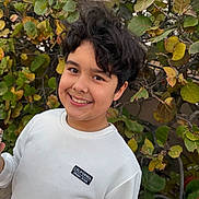 Jayden Gonzalez is registered to the contest to win money with this photo: background, bush, california_patch, casual_clothing, child, daylight, expression, face, greenery, hair, happy, leaves, nature, outdoor, person, plant, portrait, smiling, white_sweatshirt, young