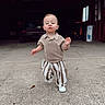 Bodhi is registered to the contest to win money with this photo: toddler, child, boy, concrete, driveway, striped_pants, knit_shirt, white_shoes, garage, vehicle, outdoor, walking, expression, face, clothing, casual, daylight, young_child, portrait, determined