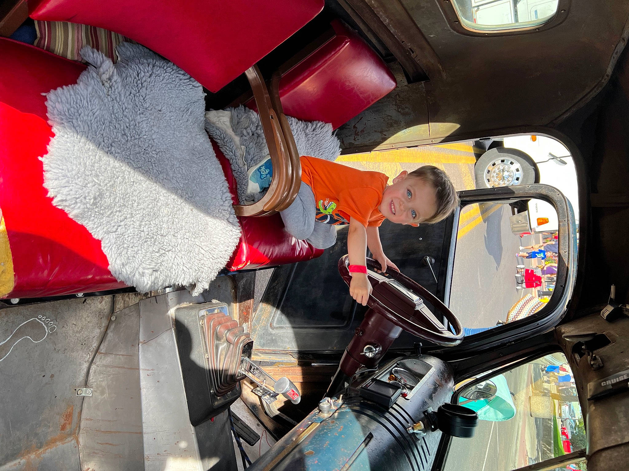 Holden is registered to the contest to win money with this photo: auto_part, automotive_design, automotive_exterior, automotive_lighting, automotive_wheel_system, bumper, carmine, event, fun, joy, machine, motor_vehicle, person, recreation, space, tire, toddler, umbrella, vehicle, vehicle_door