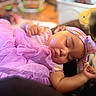 arm, baby, blanket, child, closed_eyes, cozy, face, hand, headband, home, indoors, infant, nap, peaceful, portrait, purple_dress, resting, ruffles, sleeping, soft_lighting
