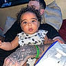 Phorever is registered to the contest to win money with this photo: adult, baby, bed, bedroom, blanket, child, curly_hair, daisy_pattern, family, fish_tank, floral_outfit, indoors, infant, pillows, portrait, sitting, smiling, tattoo, toddler, wide_eyes