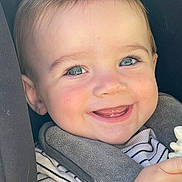 Kevan participe au concours pour gagner de l'argent avec cette photo : baby, child, smiling, face, blue_eyes, striped_clothing, bib, toy, hand, closeup, happy, cute, infant, teeth, skin, person, young_child, seat, car_seat, cozy