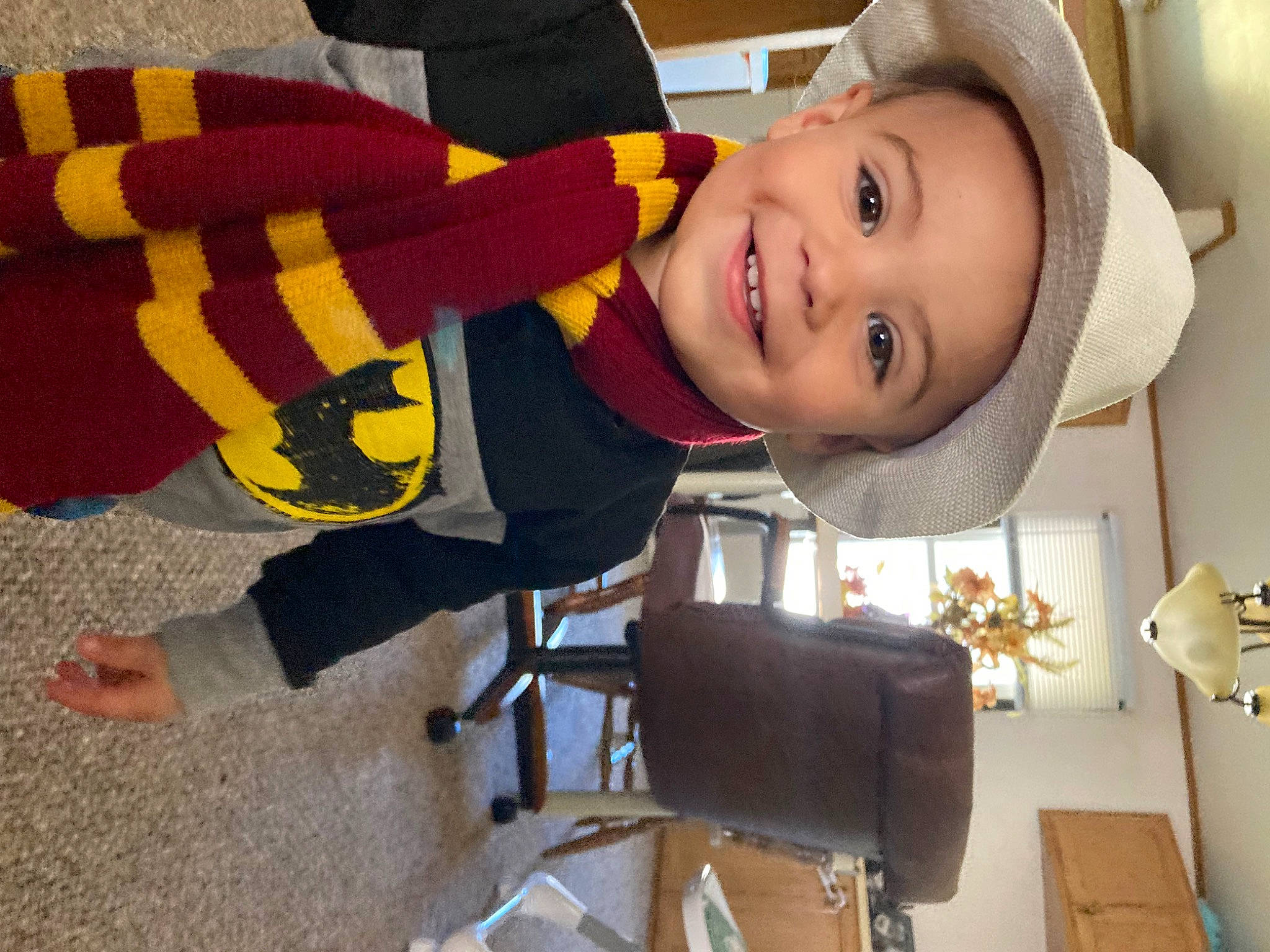Ethan is registered to the contest to win money with this photo: baby_toddler_clothing, cap, child, eye, fashion_accessory, flooring, fun, happy, hat, headgear, house, joy, leisure, person, play, room, sitting, smile, sock, sun_hat