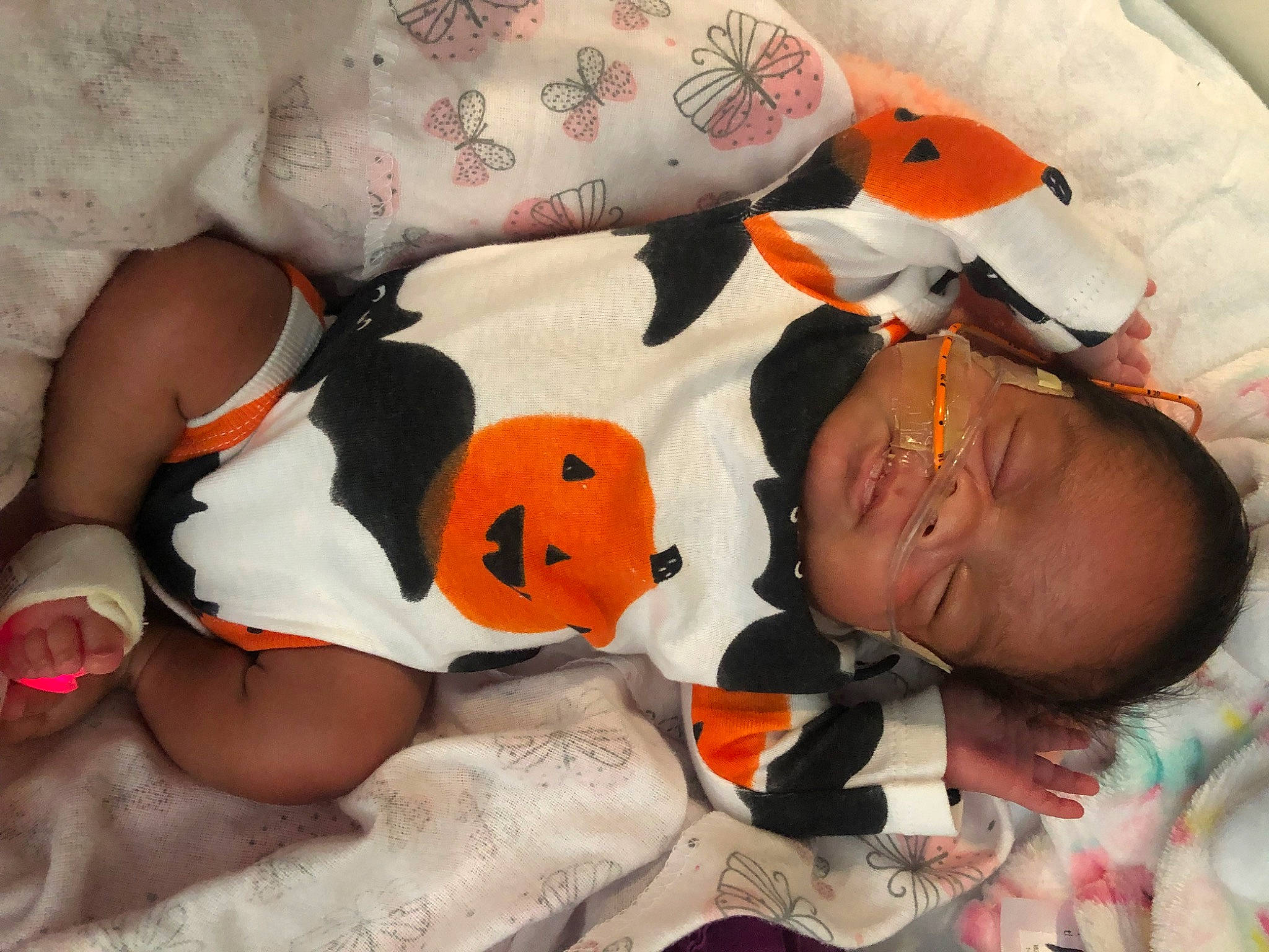 Esme is registered to the contest to win money with this photo: baby, calabaza, carmine, child, comfort, fun, fur, happy, linens, mouth, orange, pattern, person, plush, room, stuffed_toy, textile, toddler, toy, white