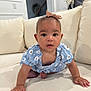 baby, child, crawling, blue_dress, headband, bow, couch, living_room, curious, wide_eyes, skin, hand, foot, indoors, soft_lighting, furniture, cute, infant, person, portrait