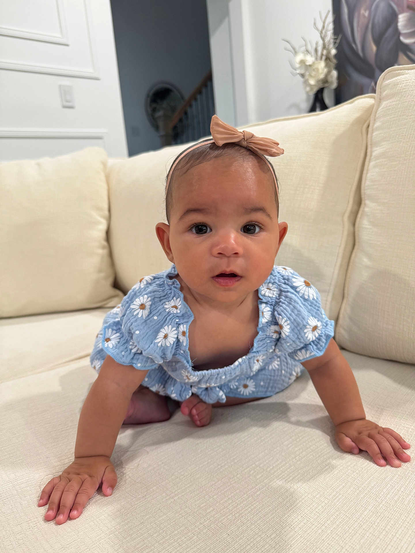 Zen is registered to the contest to win money with this photo: baby, child, crawling, blue_dress, headband, bow, couch, living_room, curious, wide_eyes, skin, hand, foot, indoors, soft_lighting, furniture, cute, infant, person, portrait