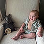 Tate joined the competition — help win amazing prizes! baby, infant, child, smiling, sitting, armchair, plush_toy, rhino, milestone_sign, striped_clothing, shorts, shirt, happy, indoors, cozy, cute, soft_texture, furniture, person, portrait