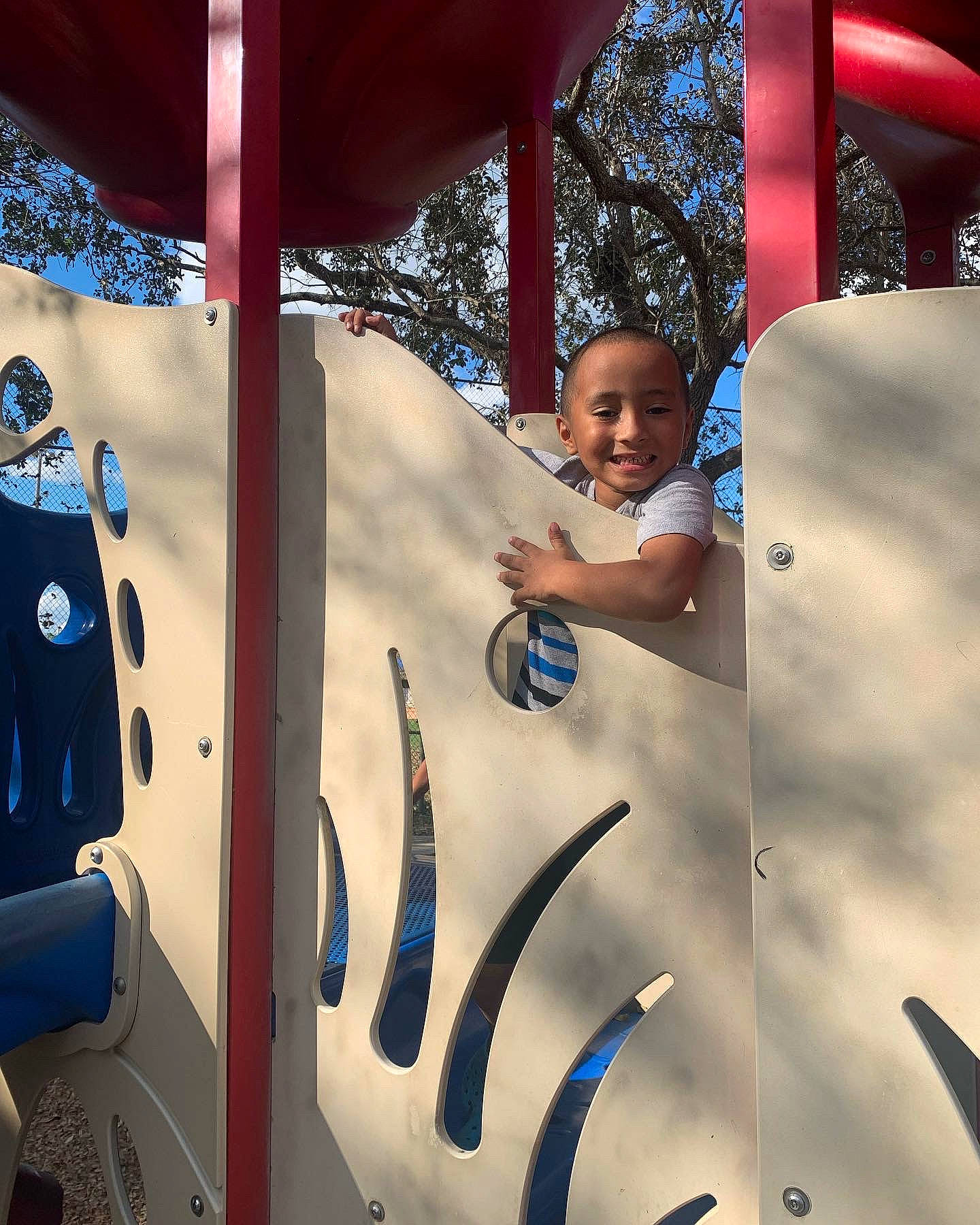 Jace is registered to the contest to win money with this photo: blue, cool, electric_blue, eyewear, fun, happy, joy, leisure, light, line, person, photograph, public_space, shade, snapshot, standing, tints_and_shades, toddler, travel, tree