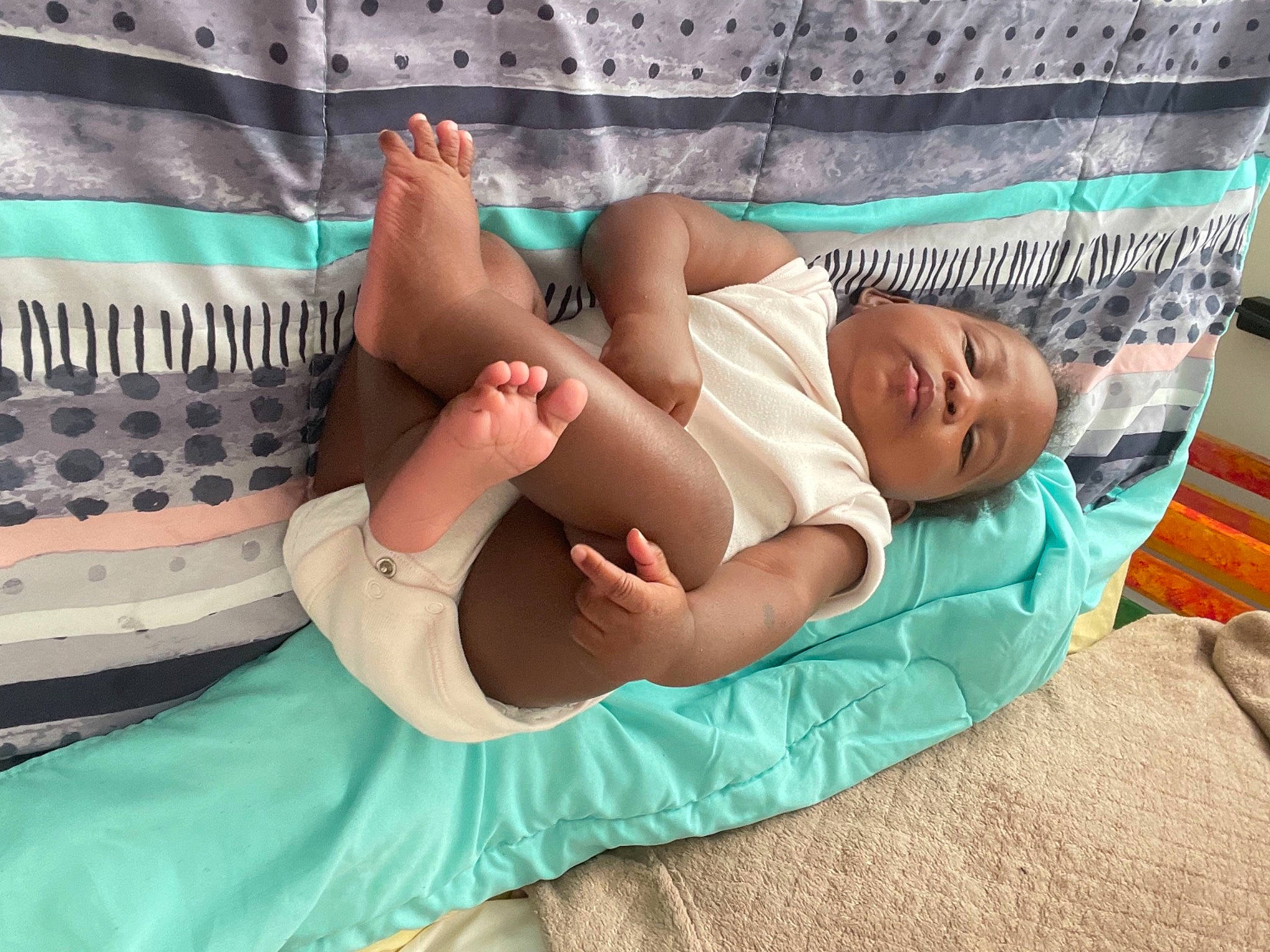 Promise is registered to the contest to win money with this photo: abdomen, arm, baby, baby_products, baby_toddler_clothing, barefoot, comfort, elbow, event, foot, human_body, human_leg, knee, leisure, linens, pattern, person, textile, thigh, toddler