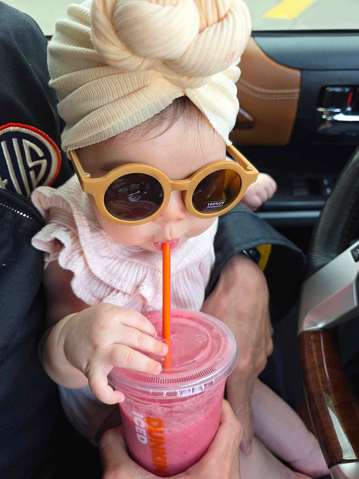 Scotti joined the competition — help win amazing prizes! baby, child, sunglasses, turban, headwrap, drink, smoothie, straw, cup, hand, adult_hand, car_interior, car_seat, window, closeup, portrait, pink_drink, fashionable, cute, sunglasses_reflection