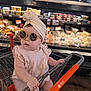 Scotti joined the competition — help win amazing prizes! baby, child, infant, sunglasses, headwrap, shopping_cart, grocery_store, cheese_section, shopping_cart_handle, pink_outfit, cute, portrait, indoor, reflection, shelves, products, food, aisle, hand, retail
