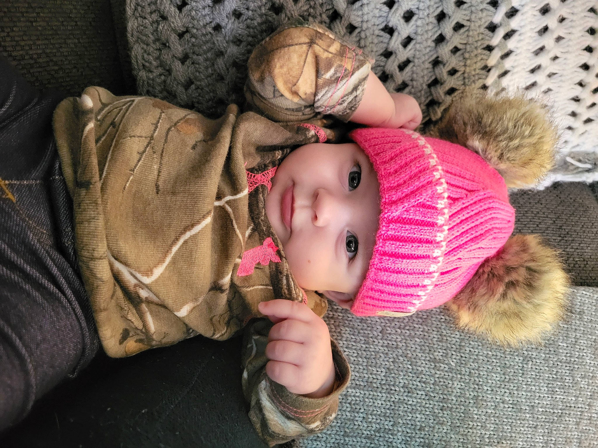 Briella is registered to the contest to win money with this photo: baby, baby_toddler_clothing, beanie, cheek, child, comfort, eye, fur, hand, headgear, headwear, knit_cap, nap, person, sitting, skin, sleep, toddler, tree, winter
