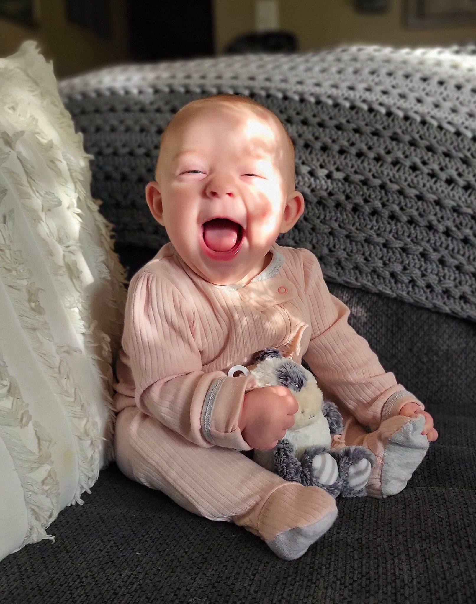 Briella is registered to the contest to win money with this photo: baby, baby_products, baby_toddler_clothing, cheek, child, comfort, couch, dress, eye, flooring, happy, human_body, linens, outerwear, pattern, person, sitting, sleeve, smile, toddler
