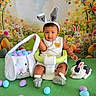 baby, bunny_ears, easter_eggs, basket, green_seat, stuffed_bunny, flowers, background, cute, child, holiday, spring, portrait, indoor, colorful, playful, smiling, festive, toy, costume