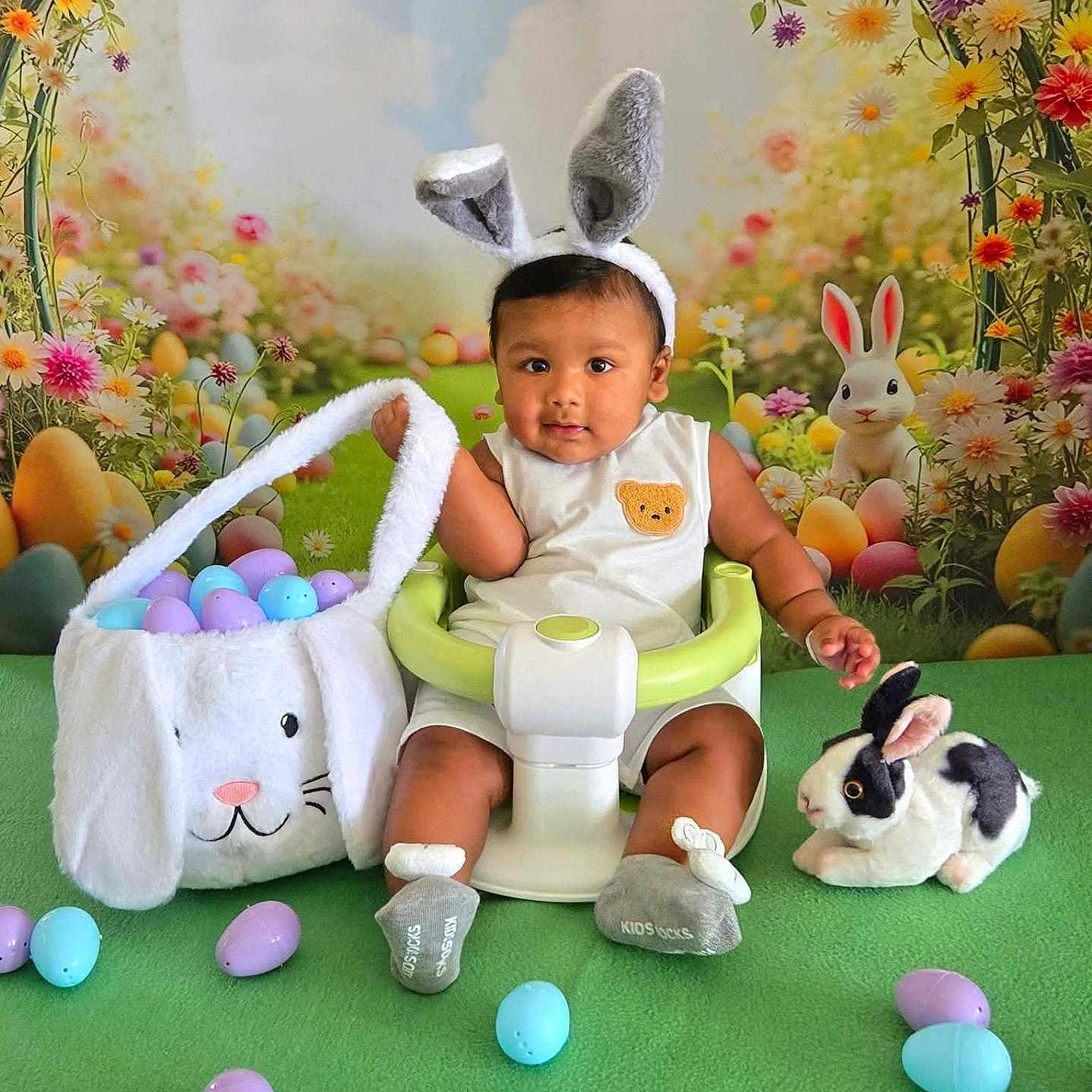Dylan is registered to the contest to win money with this photo: baby, bunny_ears, easter_eggs, basket, green_seat, stuffed_bunny, flowers, background, cute, child, holiday, spring, portrait, indoor, colorful, playful, smiling, festive, toy, costume