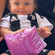 Tidjani a rejoint le concours — aidez-le/la à gagner de superbes lots ! baby, child, infant, smile, blue_eyes, topknot, black_and_white_clothing, inflatable_toy, purple_toy, sitting, barefoot, cute, happy, person, indoor, closeup, legs, hands, cute_expression, casual_clothing