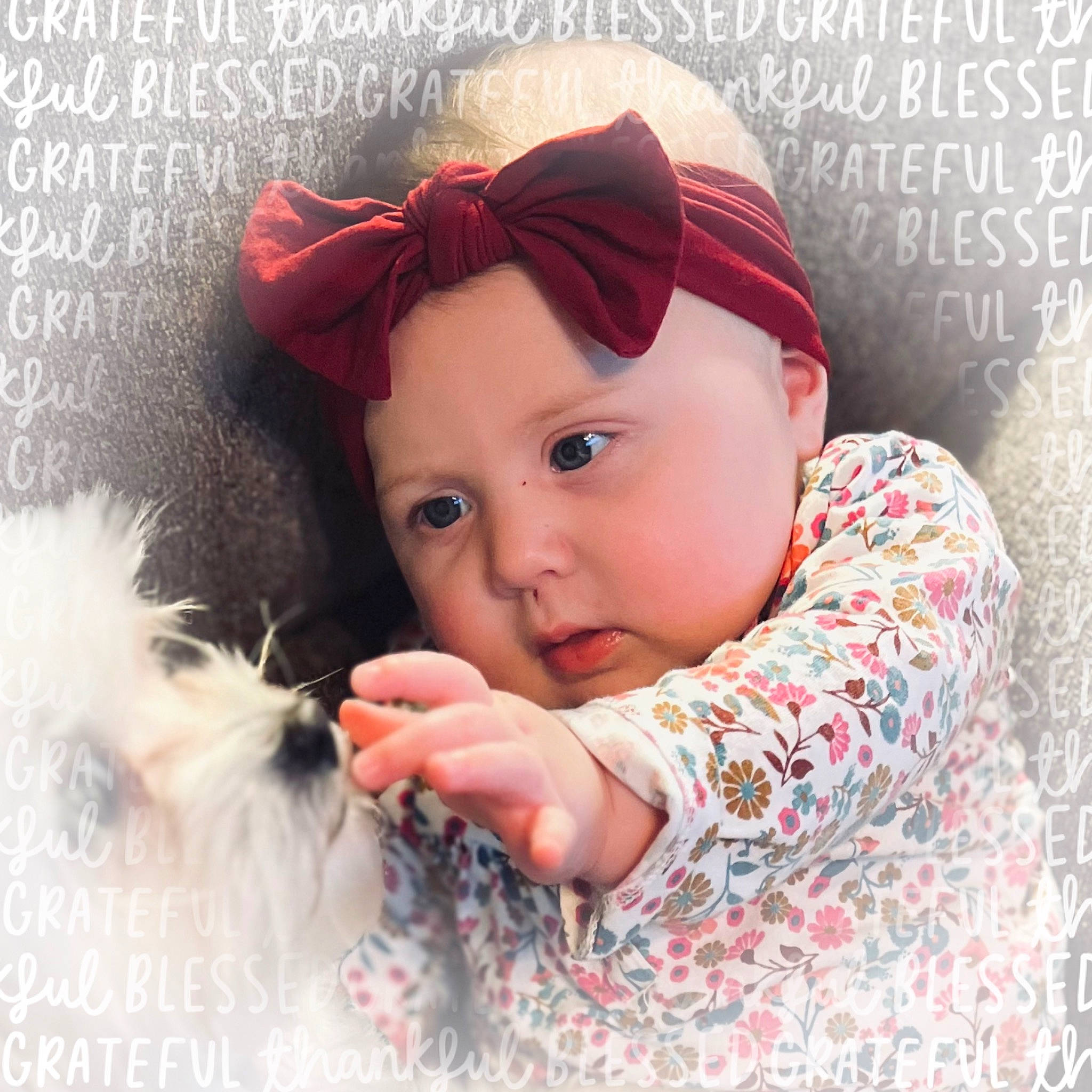 Carly is registered to the contest to win money with this photo: baby, baby_toddler_clothing, cap, child, eyelash, fashion_accessory, font, gesture, happy, headpiece, headwear, knit_cap, lip, magenta, pattern, people_in_nature, person, petal, pink, skin