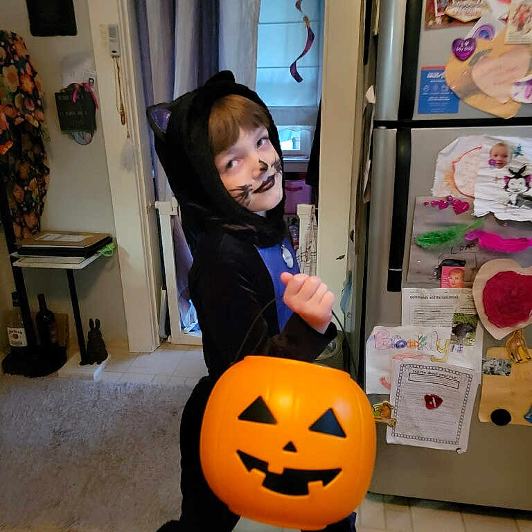 Brooklyn is registered to the contest to win money with this photo: balloon, bodypart, clothing, costume, device, face, festival, finger, food, halloween, head, jack_o_lantern, person, photography, plant, portrait, produce, shelf, squash, vegetable