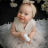Juliana participe au concours pour gagner de l'argent avec cette photo : baby, child, smile, headband, blue_eyes, dress, tulle_skirt, flower, white_flower, lace_blanket, sitting, portrait, cute, indoor, infant, holding_object, soft_lighting, closeup, happy, adorable
