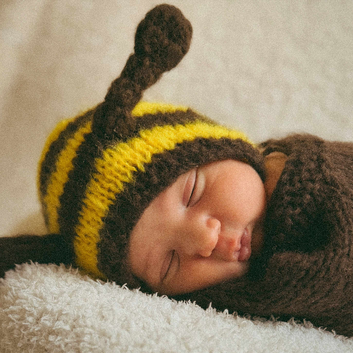 Tasho is registered to the contest to win money with this photo: baby, newborn, sleeping, knitted_hat, bee_costume, yellow, brown, soft_blanket, cute, infant, child, portrait, cozy, peaceful, resting, warm, closeup, face, headwear, sleep