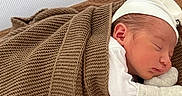 Tasho is registered to the contest to win money with this photo: baby, bed, blanket, brown_blanket, child, closeup, cozy, crib, cute, indoors, infant, mesh, mittens, newborn, peaceful, portrait, resting, sleeping, soft, white_hat