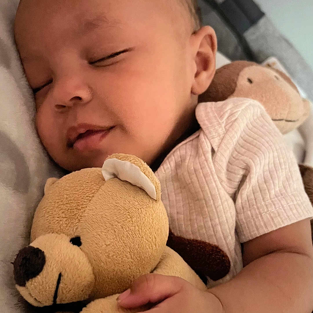 Salem is registered to the contest to win money with this photo: baby, sleeping, teddy_bear, soft_toy, hand, face, infant, cozy, bed, blanket, cute, child, peaceful, resting, portrait, indoor, comfort, sleep, clothing, smile