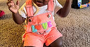 Kreari joined the competition — help win amazing prizes! baby, bottle, carpet, child, clothing, cute, expression, floor, hair_puffs, heart_shaped, indoor, love_patch, orange, overalls, person, pink, playtime, sunglasses, toddler, toy