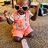 Kreari joined the competition — help win amazing prizes! toddler, child, sunglasses, heart_shaped, overalls, love_patch, carpet, bottle, indoor, playtime, cute, pink, orange, baby, person, clothing, hair_puffs, toy, floor, expression