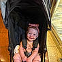 Selyhia is registered to the contest to win money with this photo: baby, child, stroller, pink_headband, smiling, indoors, flooring, black_stroller, happy, infant, seatbelt, cute, person, headwear, toddler, clothing, footwear, seat, portrait, childcare