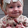 baby, child, smile, headband, bow, floral_clothing, hands, nail_polish, sunglasses, person, portrait, cute, outdoor, happy, face, young_child, holding, red_hair, closeup, infant