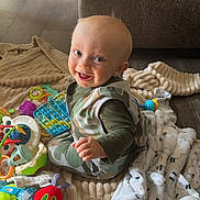 Waylon joined the competition — help win amazing prizes! architecture, baby, blanket, building, clothing, couch, cushion, face, furniture, head, homedecor, indoors, livingroom, pants, person, photography, portrait, room, sitting, toy