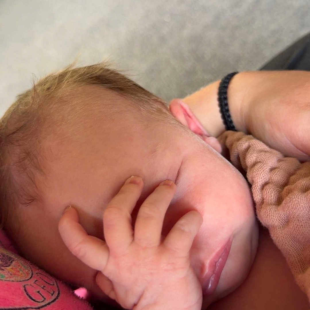 Neyland is registered to the contest to win money with this photo: baby, sleeping, hand, face, person, arm, skin, clothing, pink, comfort, rest, tired, cute, newborn, outdoor, closeup, expression, infant, nap, casual