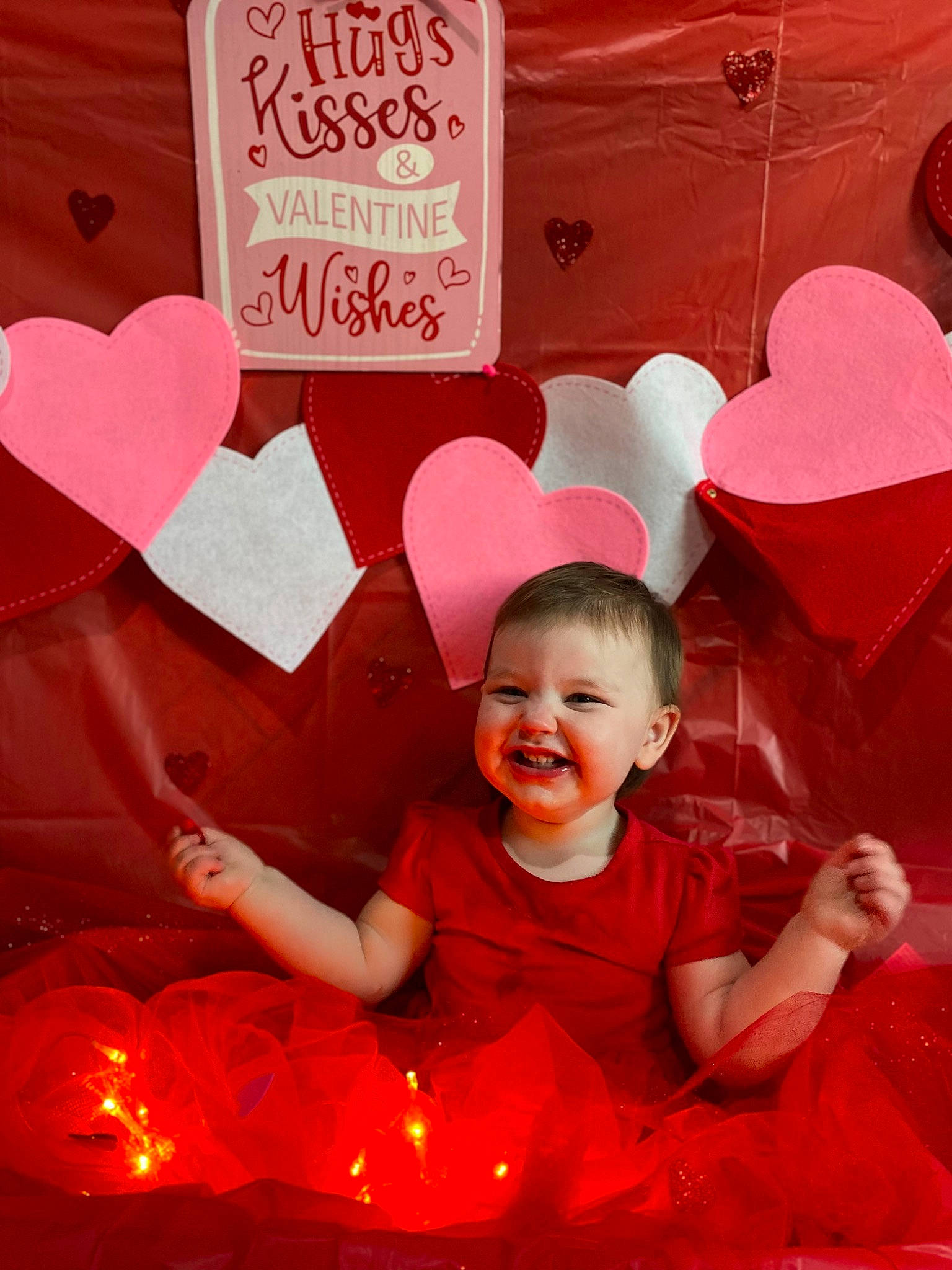 Hope is registered to the contest to win money with this photo: baby, baby_toddler_clothing, beauty, event, font, fun, gesture, happy, heart, holiday, joy, lighting, magenta, organ, party_supply, person, pink, red, smile, snapshot
