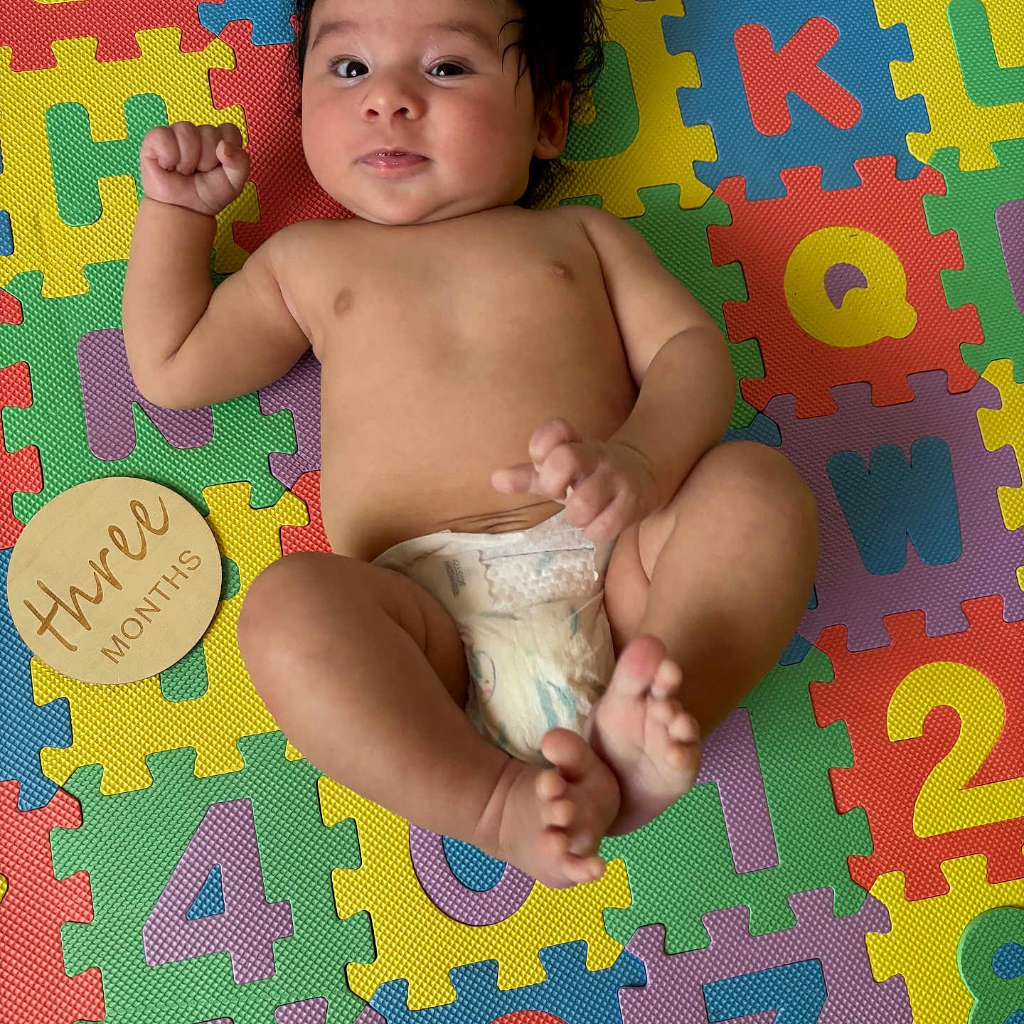 Lucio is registered to the contest to win money with this photo: baby, barefoot, blanket, bodypart, diaper, face, finger, furniture, hand, head, homedecor, mat, newborn, pattern, person, photography, portrait, quilt, sitting, toe