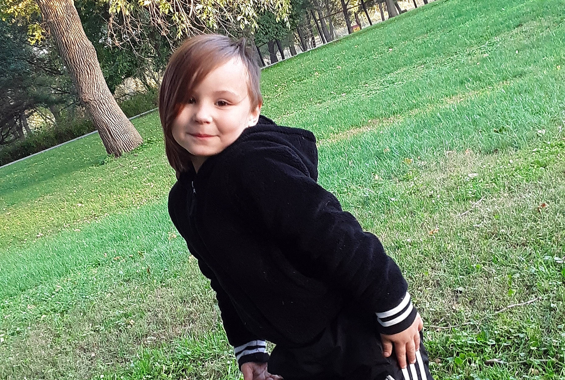 Aaralyn is registered to the contest to win money with this photo: child, fun, grass, green, happy, jacket, joy, lawn, leaf, leisure, person, photography, plant, sitting, sleeve, smile, tree