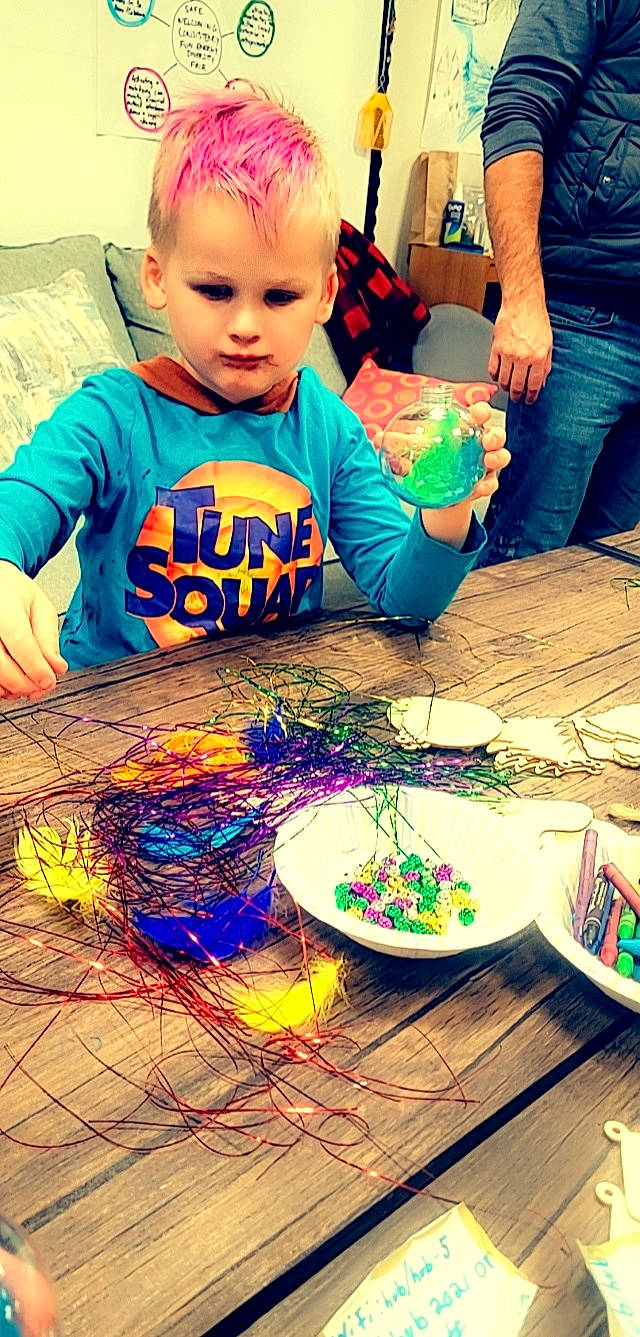 Xavier joined the competition — help win amazing prizes! art, artist, child, clothing, eyewear, flooring, fun, green, happy, head, holiday, indoor_games_and_sports, person, play, recreation, sharing, sitting, t_shirt, table, toddler