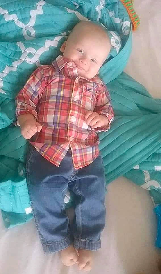 Xavier is registered to the contest to win money with this photo: baby_toddler_clothing, child, comfort, cool, denim, fun, green, happy, linens, pattern, person, plaid, shorts, sitting, sleeve, smile, t_shirt, tartan, textile, thigh
